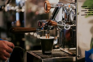 A coffee machine pouring coffee into a mug